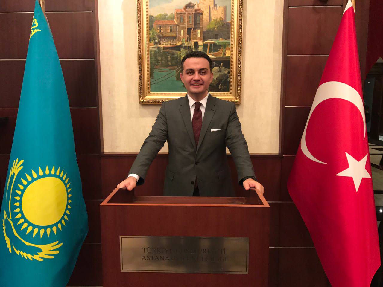 Tevfik Tolga Kavun with the flags of Kazakhstan and Turkey